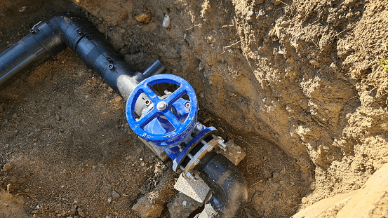 Blue faucet to control sewerage system in ground